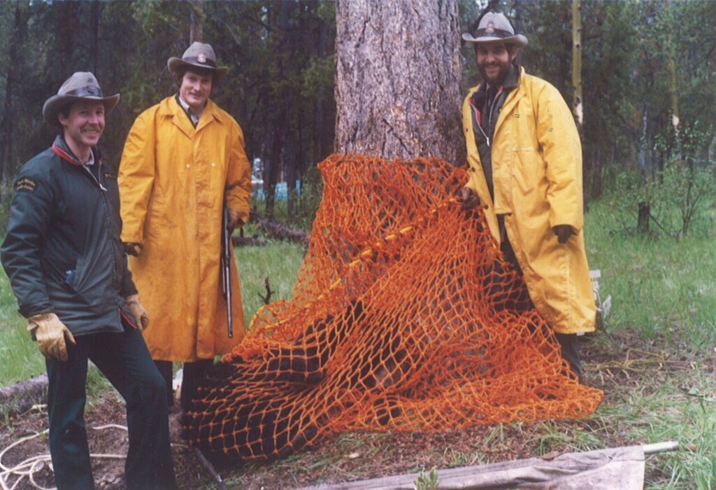Ian Pengelly, Mike Gibeau and Chris Worobets with bear in net.